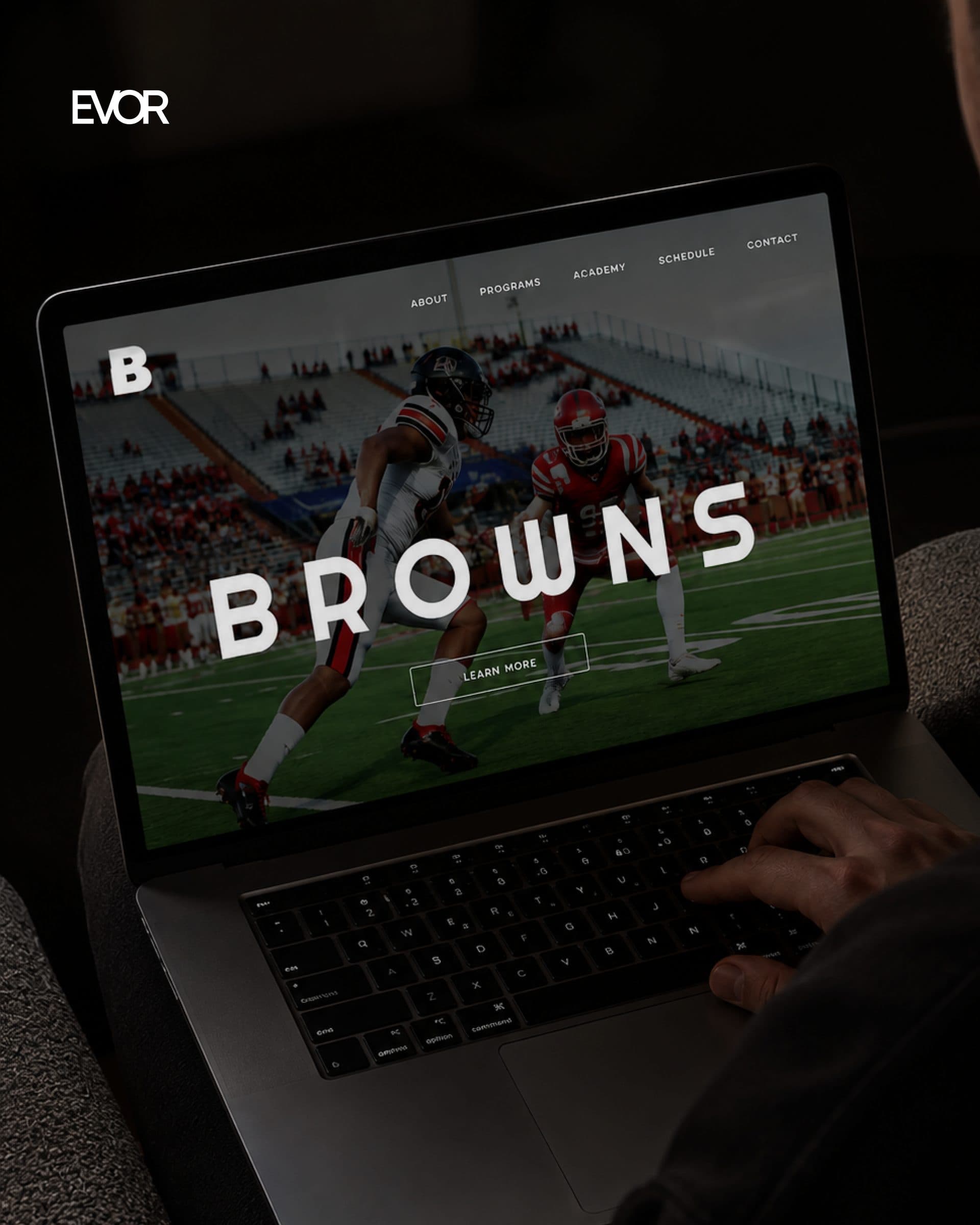 Browns cover: the academy home page on a laptop, the match photograph running full bleed.