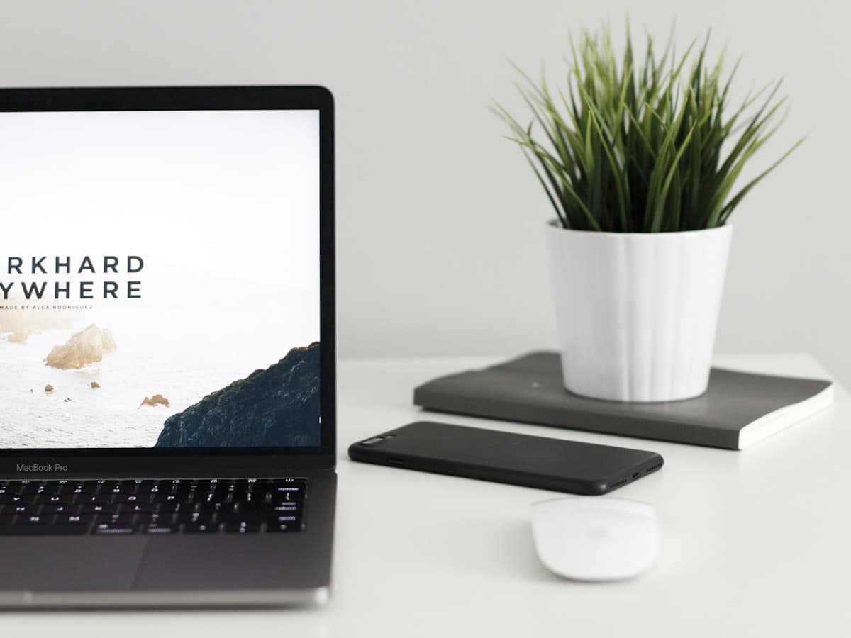 Placeholder cover. A laptop and phone on a plain white desk.
