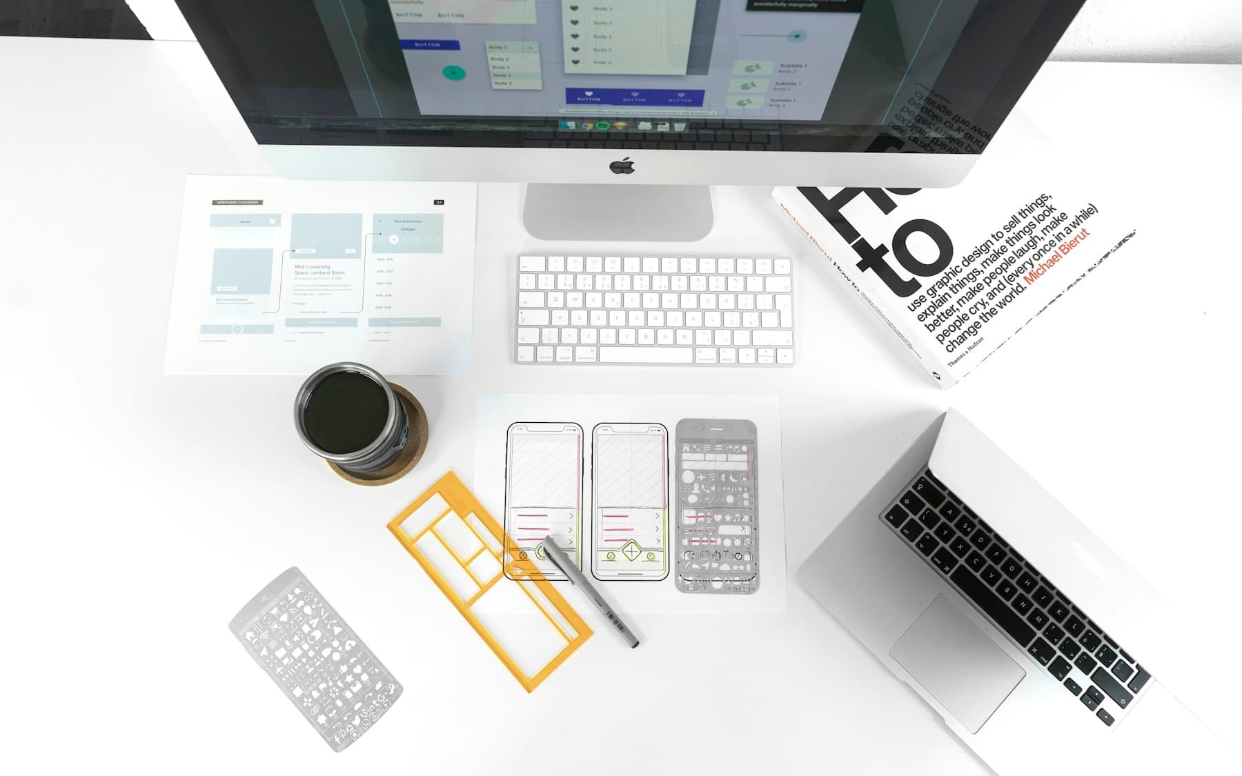 Placeholder cover. Interface wireframes and phone screens laid out on a white desk.